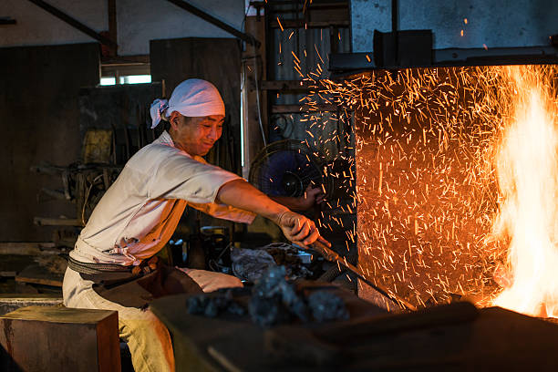 istock Japanese blacksmith stokes a fire preparing to forge a sword 612661778