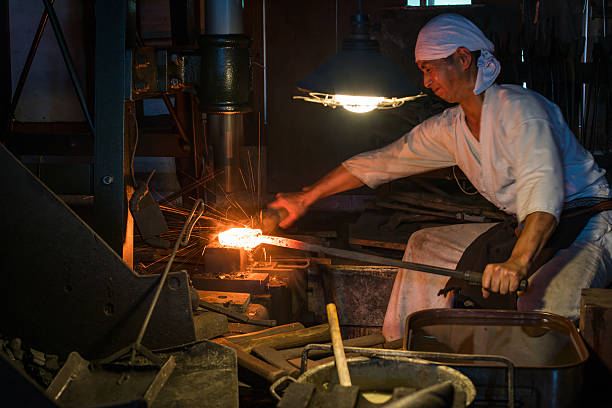 istock Blacksmith pounding red hot steel with mechanical hammer 612713778