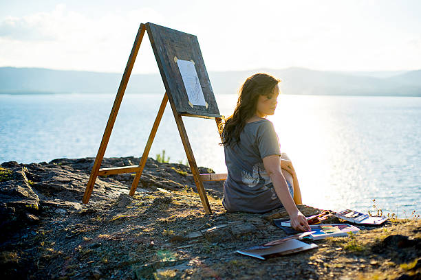 istock young artist draws a seascape at sunset 612717964