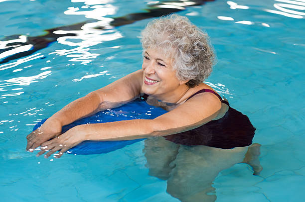 istock Senior woman swimming 612717978