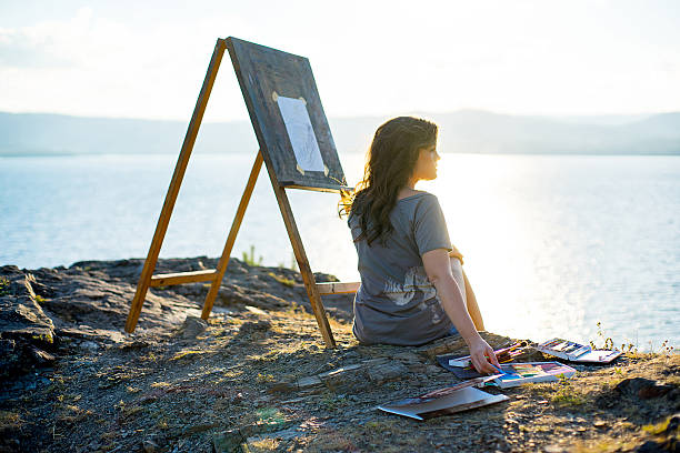 istock young artist draws a seascape at sunset 612718140