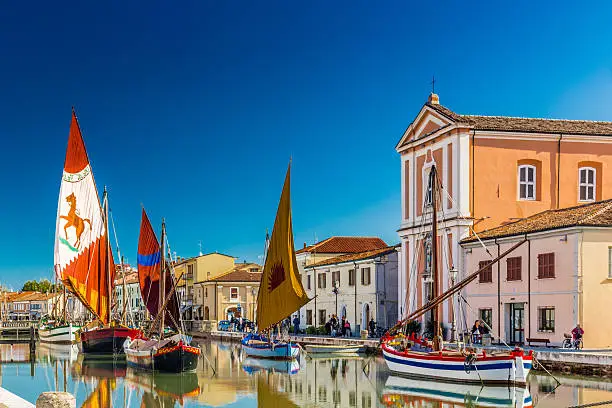 Photo of Church and ancient sailboats on Canal Port