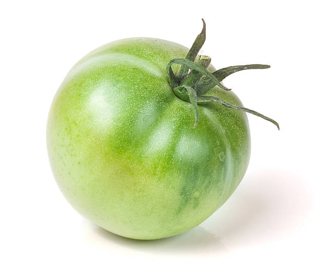 istock one green unripe tomato isolated on white background 612719506