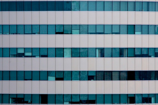 Office Building Exterior facade close up blue green and aluminum.