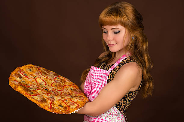 istock beautiful woman with pizza in hands 612722684