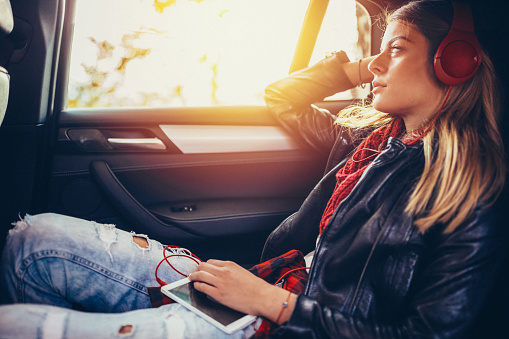 Woman on a road trip listening to the music