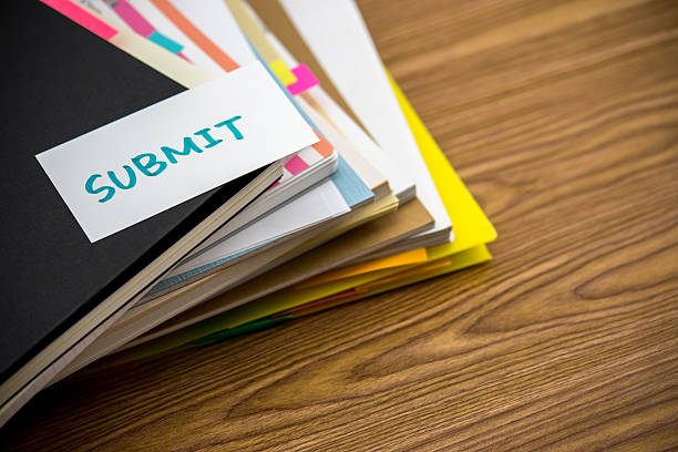 istock Submit; The Pile of Business Documents on the Desk 612723370