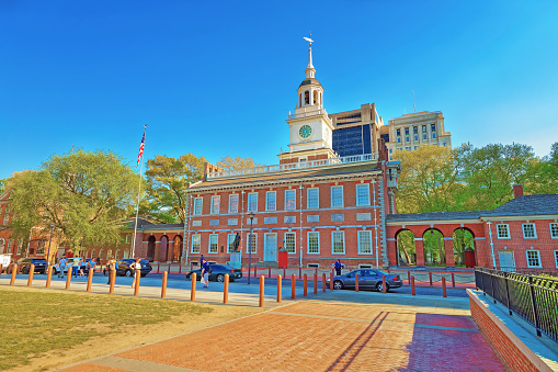 Philadelphia, USA - May 4, 2015: Independence Hall in Philadelphia, in Pennsylvania, USA. It is the place where the US Constitution and the US Declaration of Independence were adopted. Tourists in the street