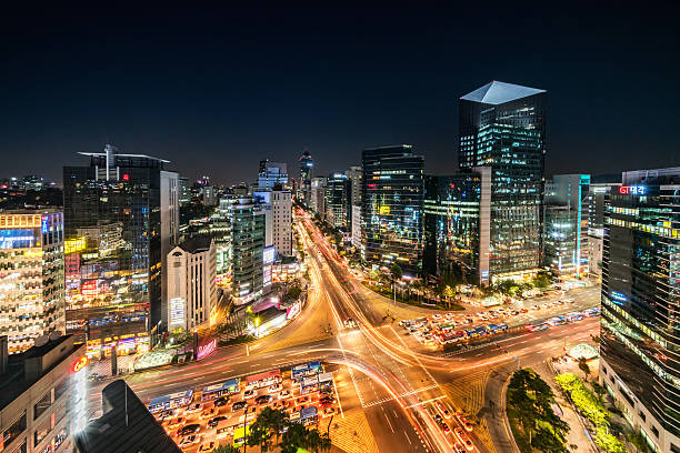 Aerial View Gangnam at Night Seoul Korea Aerial view of famous crowded Crossing at Downtown Gangnam Station at night with traffic and surrounding tall skyscrapers. New Voigtlander Helinar 10mm Ultra Wide Angle, Unique Perspective, 42MP shot from aerial perspective. Gangnam District, Seoul, South Korea kangnamgu stock pictures, royalty-free photos & images