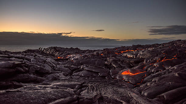 Field of lava on the Pacific coast at dawn Walking on a field of lava on the Pacific coast near Kalapana on the Big Island of Hawaii at dawn. hawaii volcanoes national park photos stock pictures, royalty-free photos & images