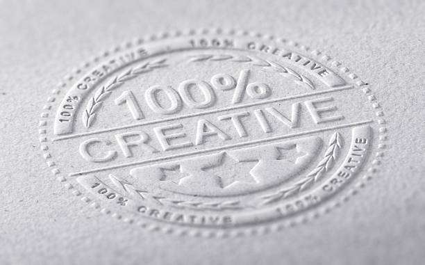 Creative Graphic Design 3D illustration of a stamp embossed on a paper texture with the text one hundred percent creative, horizontal image. Communication concept for creative advertising company brocade stock pictures, royalty-free photos & images