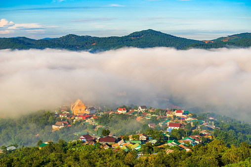 Landscape of houses on the mountain on foggy day in early morning at Da Lat, Vietnam