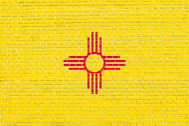 New Mexican official flag, symbol. American patriotic element. USA banner. United States of America background. Flag of the US state of New Mexico on brick wall texture background