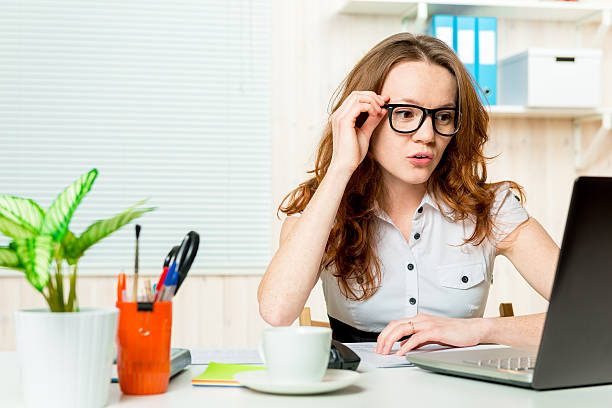 istock attentive young accountant looking at a laptop in the office 612728230