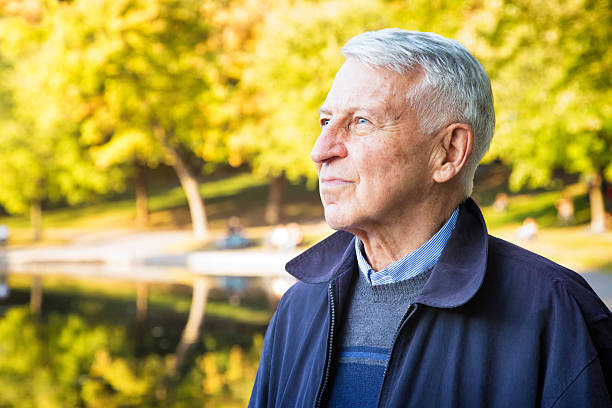 Hopeful confident senior man out in park