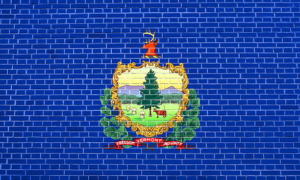 istock Flag of Vermont on brick wall texture background 612729256