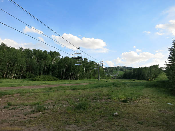 istock Gondola line goes up mountain as it sits empty 612730674