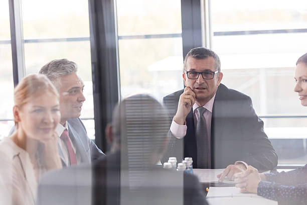 istock Multi-ethnic business people having discussion in board room at office 612730980