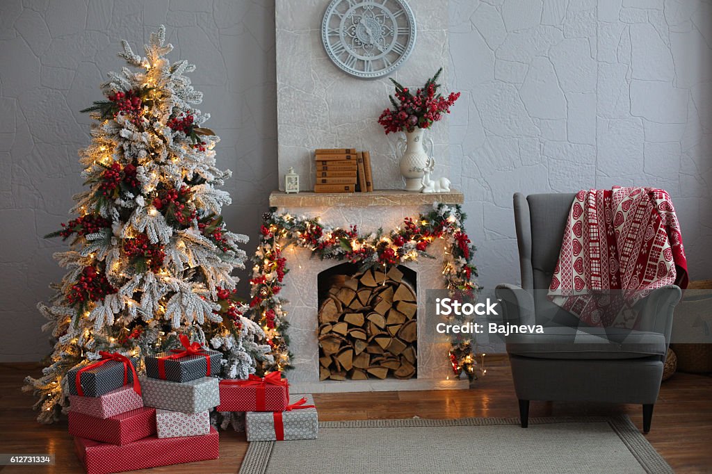 Christmas Tree in Room, Xmas Home Night Interior Christmas home decoration with tree, gifts and fireplace. Christmas Stock Photo