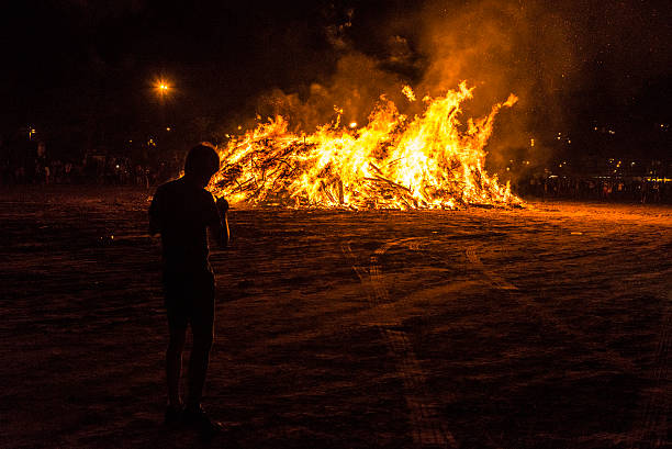 istock Boy on a bonfire on a beach at night, Spain 612732766