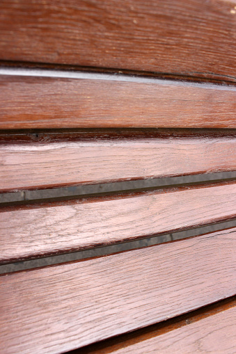 Close up and upper view on a wooden bench rest back cut out wooden brown slats