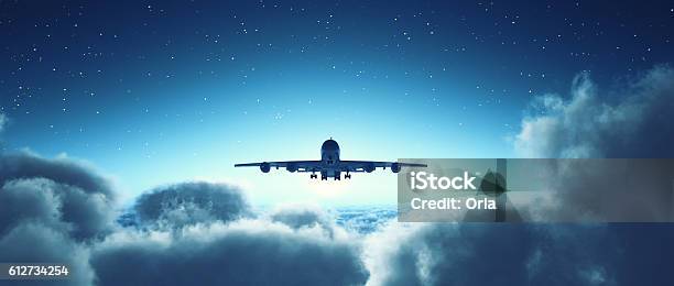 Airplane Flying Over Cloudy Sky Stock Photo - Download Image Now - Airplane, Dreamlike, Flying