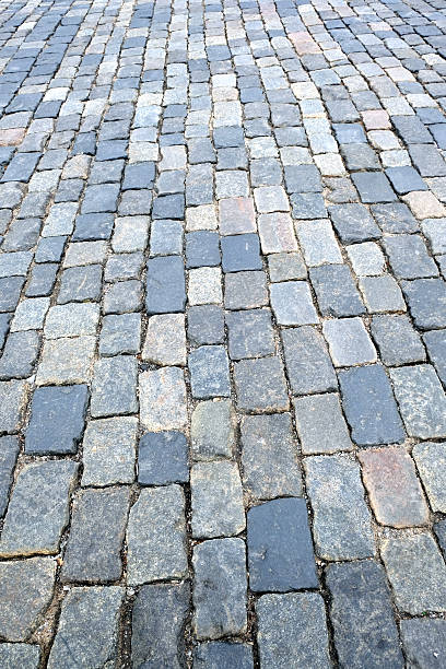 istock Gray cobblestone street closeup 612734534