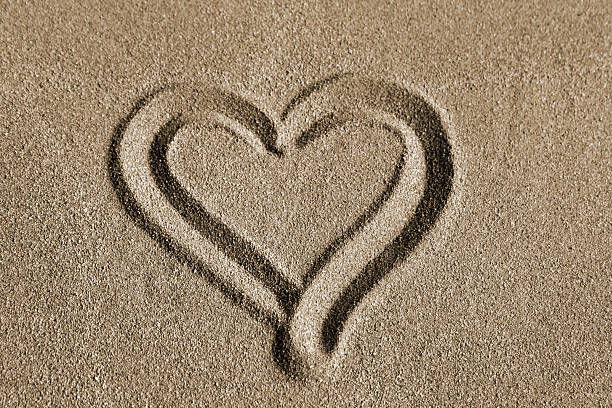 istock Heart drawn on a sand, valentines day on the beach 612734794