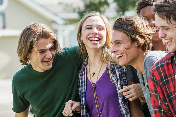 istock Group of five multi-ethnic teenagers hanging out 612736084