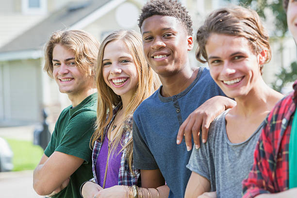 istock Group of multi-ethnic teenagers hanging out 612736156