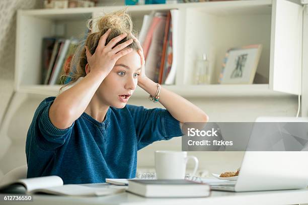Portrait Of An Attractive Woman At Table Grabbing Her Head Stock Photo - Download Image Now