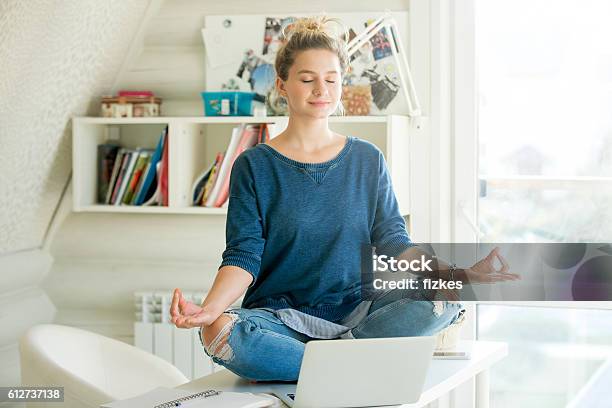 Portrait Of An Attractive Woman At Table Lotus Pose Stock Photo - Download Image Now