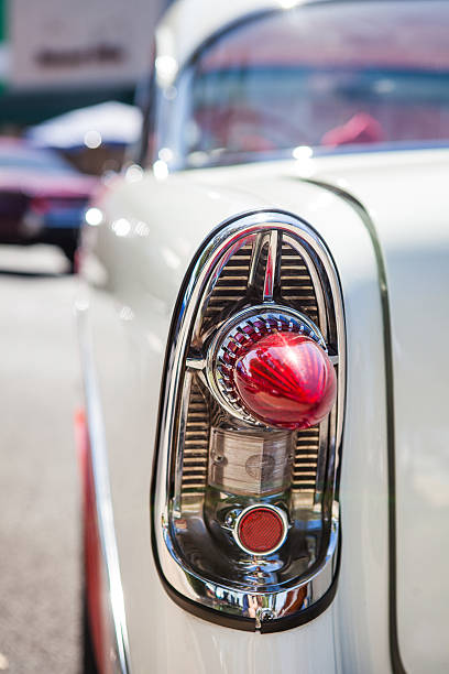 istock Part of a white old car with red headlamp 612738314