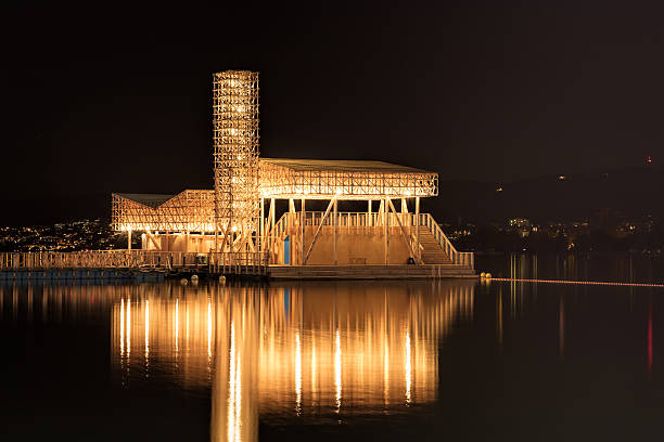 Zurich, Switzerland - 20 July, 2016: Pavilion of Reflections on Lake Zurich at night. The Pavilion of Reflections is a floating island with an open-air cinema and swimming pool. It was built for Manifesta 11 taking place in Zurich from 11 June to 18 September 2016. Manifesta is the European Biennial of Contemporary Art.