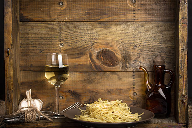 Italian pasta and glass of white wine stock photo
