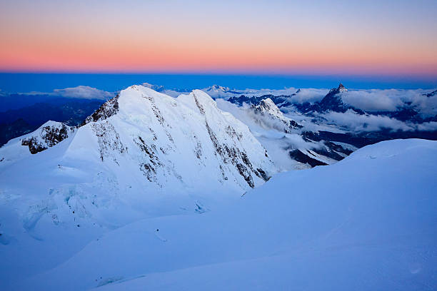 istock Top Alpine peaks right before sunrise 612739474