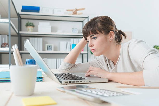 istock Disappointed woman working with a laptop 612741104