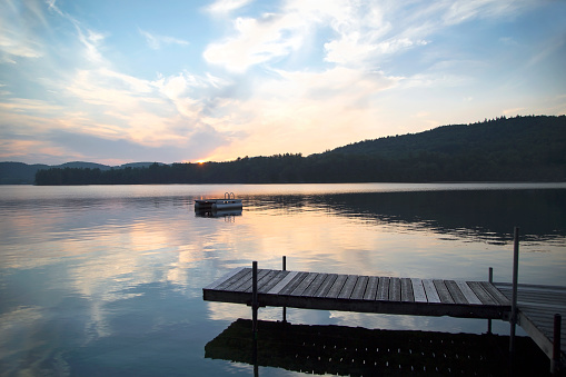 A dock and diving platform on Little Squam Lake, New Hampshire, at sunset