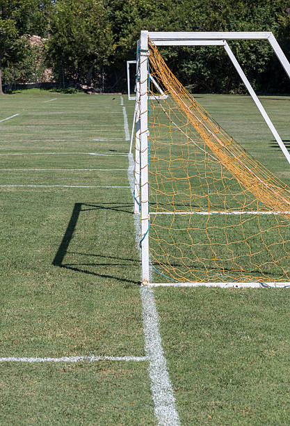 istock Soccer Goal with yellow net fallen down 612744150