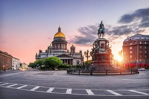 St. Isaac's Cathedral under the blue sky and pink monument to Nicholas the First on St. Isaac's Square in the early morning