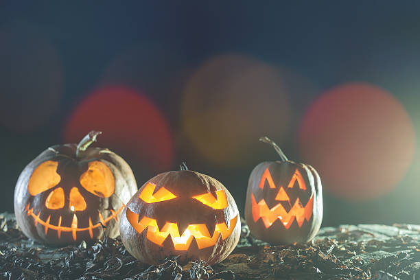 istock Halloween pumpkins at wood background. 612746884