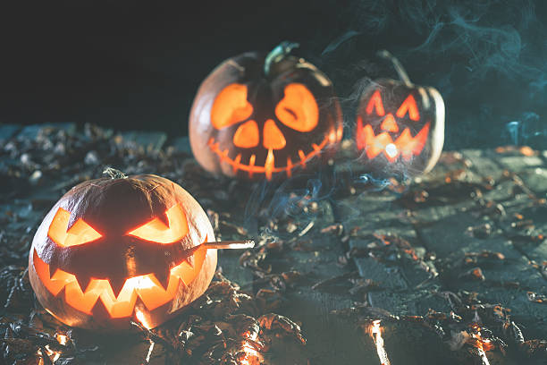 istock Cool pumpkin smoking a cigarette at halloween 612747238