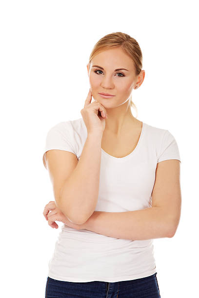 istock Young  woman with folded hands and finger on cheek 612747250