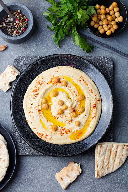 istock Hummus, chickpea dip, with spices and pita, flat bread. 612748536