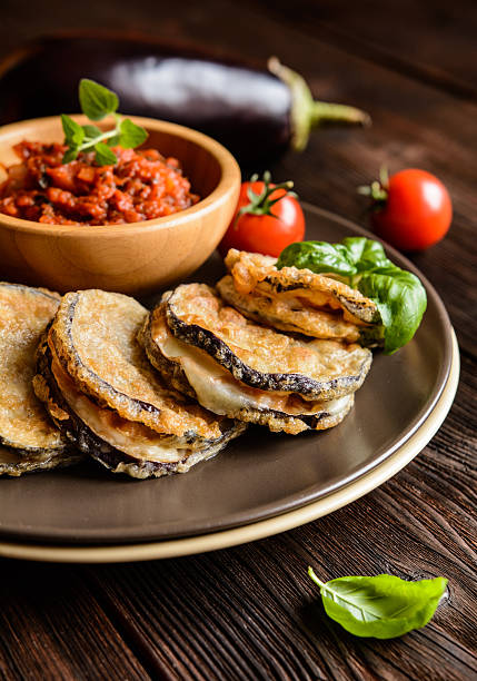 istock Eggplant stuffed with Mozzarella, served with tomato salsa 612749714