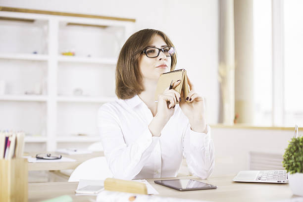 istock Woman daydreaming in office 612749914