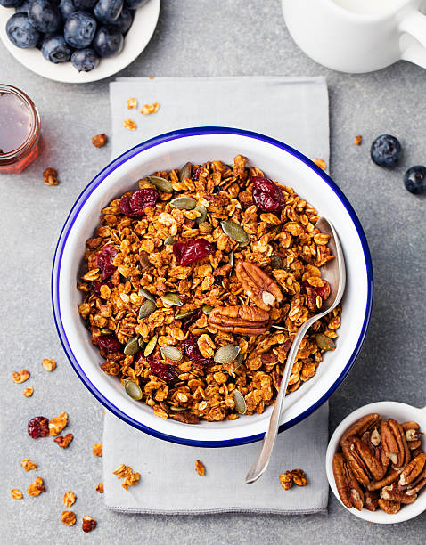 istock Healthy breakfast. Fresh granola, muesli with pumpkin, pecans, maple syrup 612750670