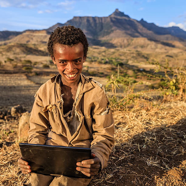 istock Young African boy is using digital tablet, East Africa 612751852