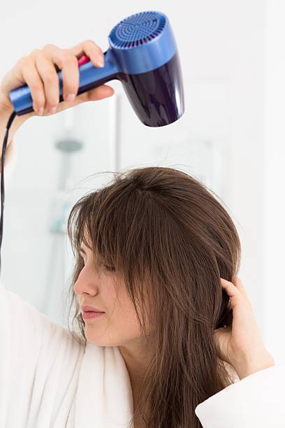 istock Trying her new hairdryer 612752586