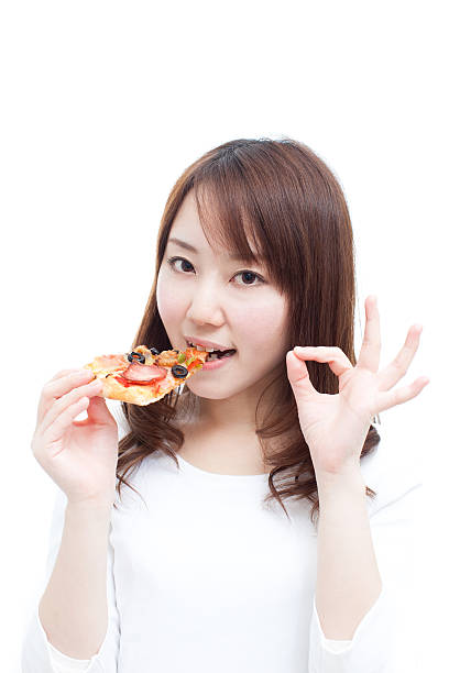 istock Japanese woman eating pizza 612753434